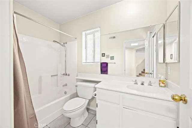 a bathroom with a sink toilet vanity and shower