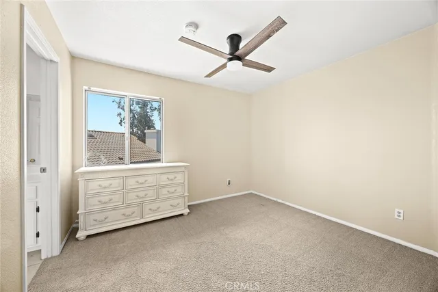 a view of room with cabinet and ceiling fan