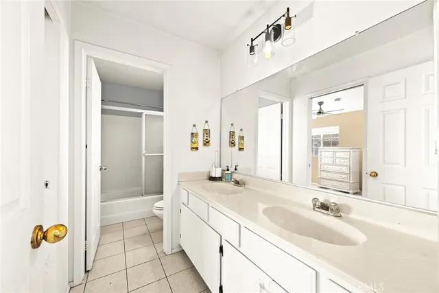 a bathroom with a granite countertop sink mirror and bathtub