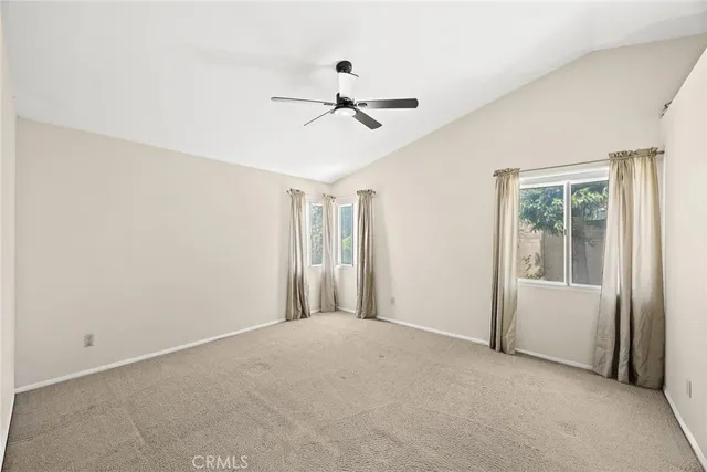 a view of a livingroom with a ceiling fan and window