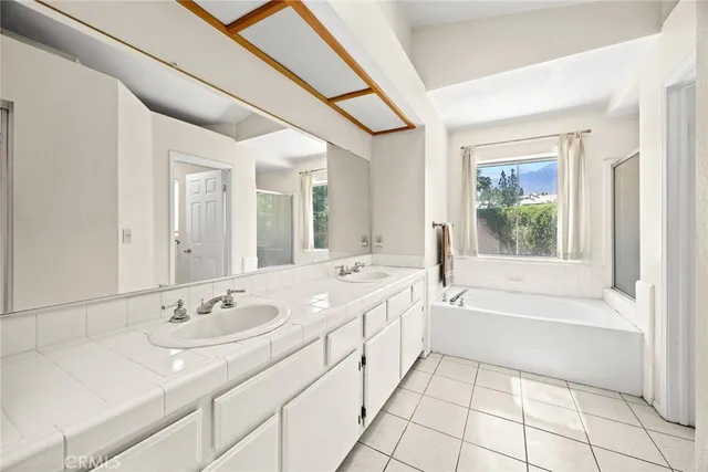 a bathroom with a tub sink and mirror