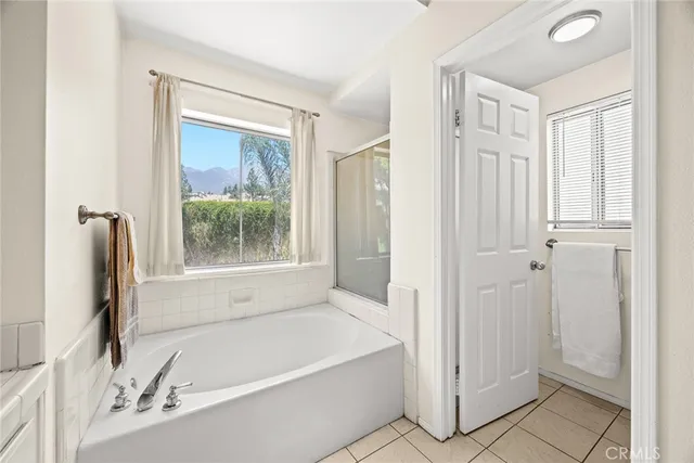 a bathroom with a tub shower and a sink