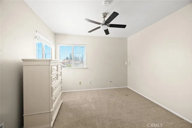 a view of a livingroom with a ceiling fan and window