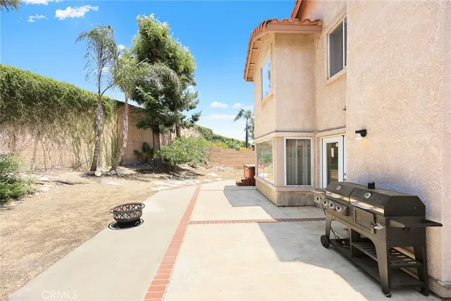 a view of a backyard with couches and a fire pit