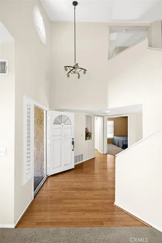 a view of a living room a ceiling fan and wooden floor