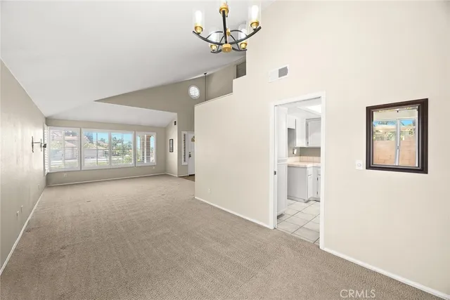 a view of livingroom with chandelier fan and window