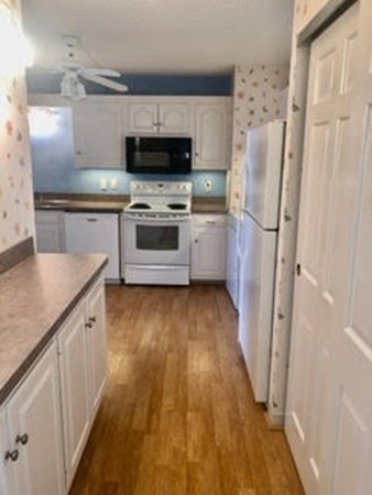 804 Ferncroft Tower, Unit 804 Middleton, MA 01949 - Photo 17 of 33 a kitchen with stainless steel appliances a stove a sink and a refrigerator