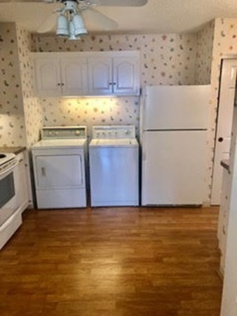 804 Ferncroft Tower, Unit 804 Middleton, MA 01949 - Photo 18 of 33 a view of kitchen with refrigerator stove and wooden cabinets