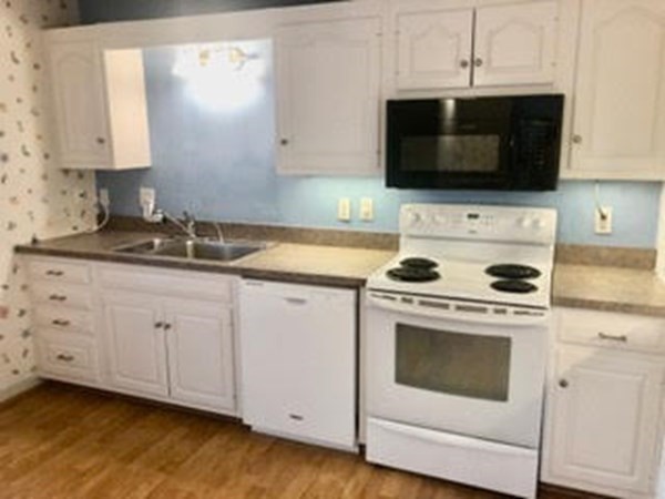 804 Ferncroft Tower, Unit 804 Middleton, MA 01949 - Photo 19 of 33 a kitchen with cabinets stainless steel appliances a sink and a stove