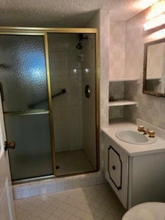 804 Ferncroft Tower, Unit 804 Middleton, MA 01949 - Photo 22 of 33 a bathroom with a sink and mirror