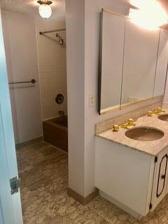 804 Ferncroft Tower, Unit 804 Middleton, MA 01949 - Photo 26 of 33 a bathroom with a sink and a mirror