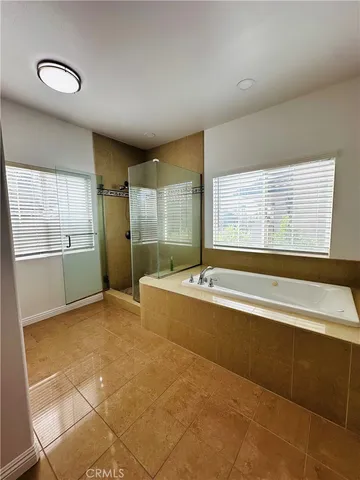 a large spacious bathroom with a large tub and shower