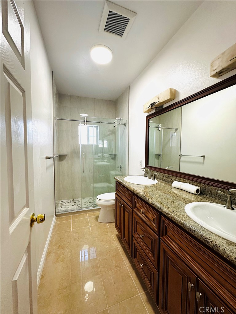 232 Genoa Street, Unit B Arcadia, CA 91006 - Photo 12 of 16 a spacious bathroom with a granite countertop sink a toilet a mirror and shower