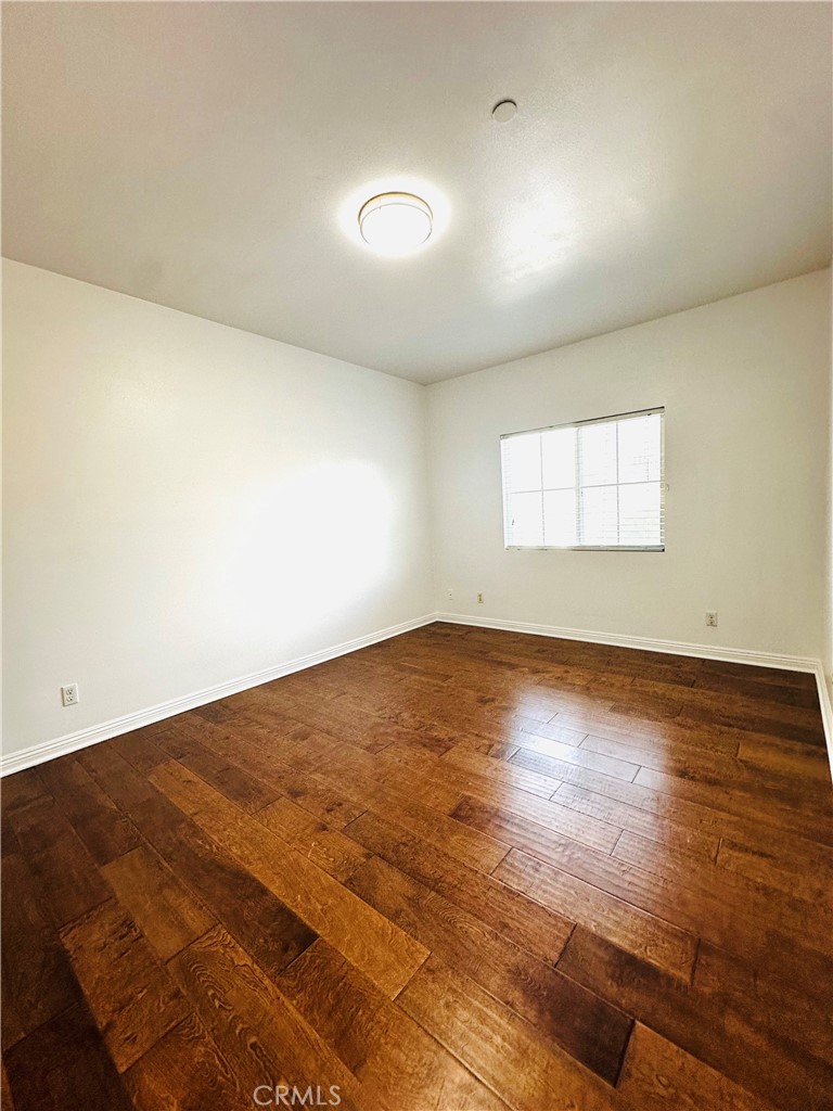 232 Genoa Street, Unit B Arcadia, CA 91006 - Photo 13 of 16 an empty room with wooden floor and windows