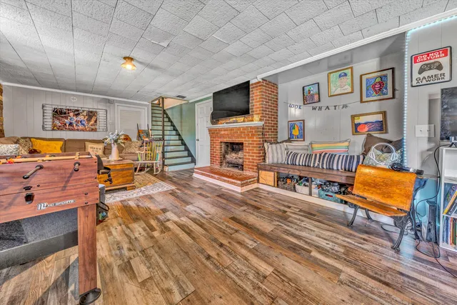 a view of a livingroom with furniture a flat screen tv and windows