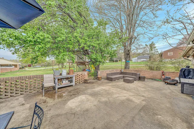a view of a porch with furniture and a yard