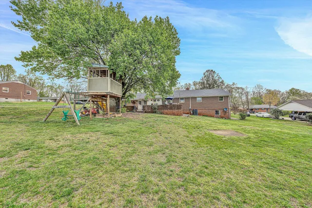 a backyard of a house with table and chairs