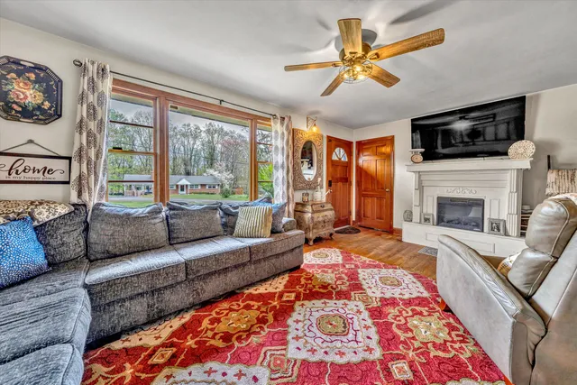 a living room with furniture fireplace and a flat screen tv