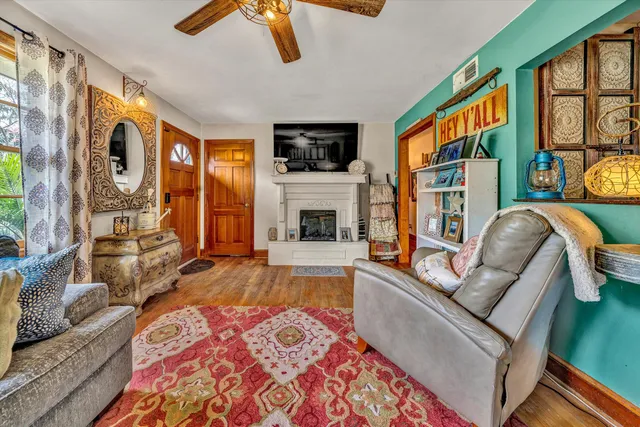 a living room with furniture fireplace and flat screen tv