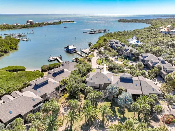 a living room with furniture a window and a flat screen tv