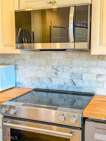 a stove top oven sitting inside of a kitchen