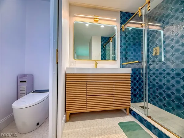 a large bed sitting in a bedroom next to a lamp