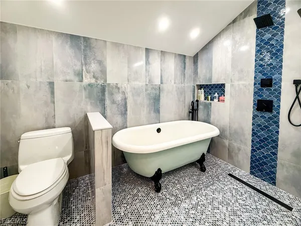 a bathroom with a shower and a sink