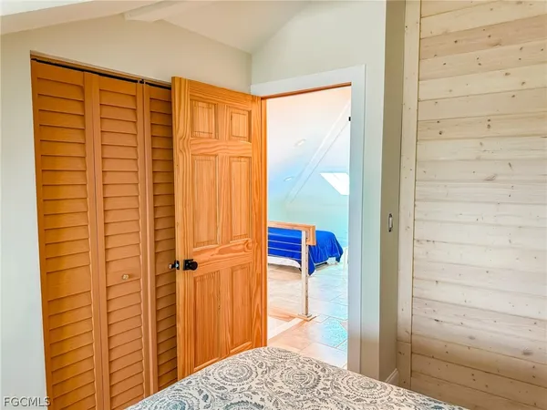 en empty room with window and wooden floor