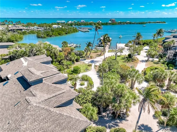 a view of a lake with lawn chairs
