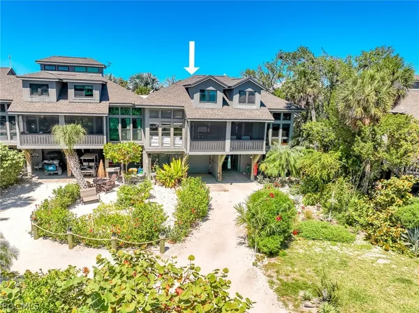 a front view of a house with a yard table and chairs