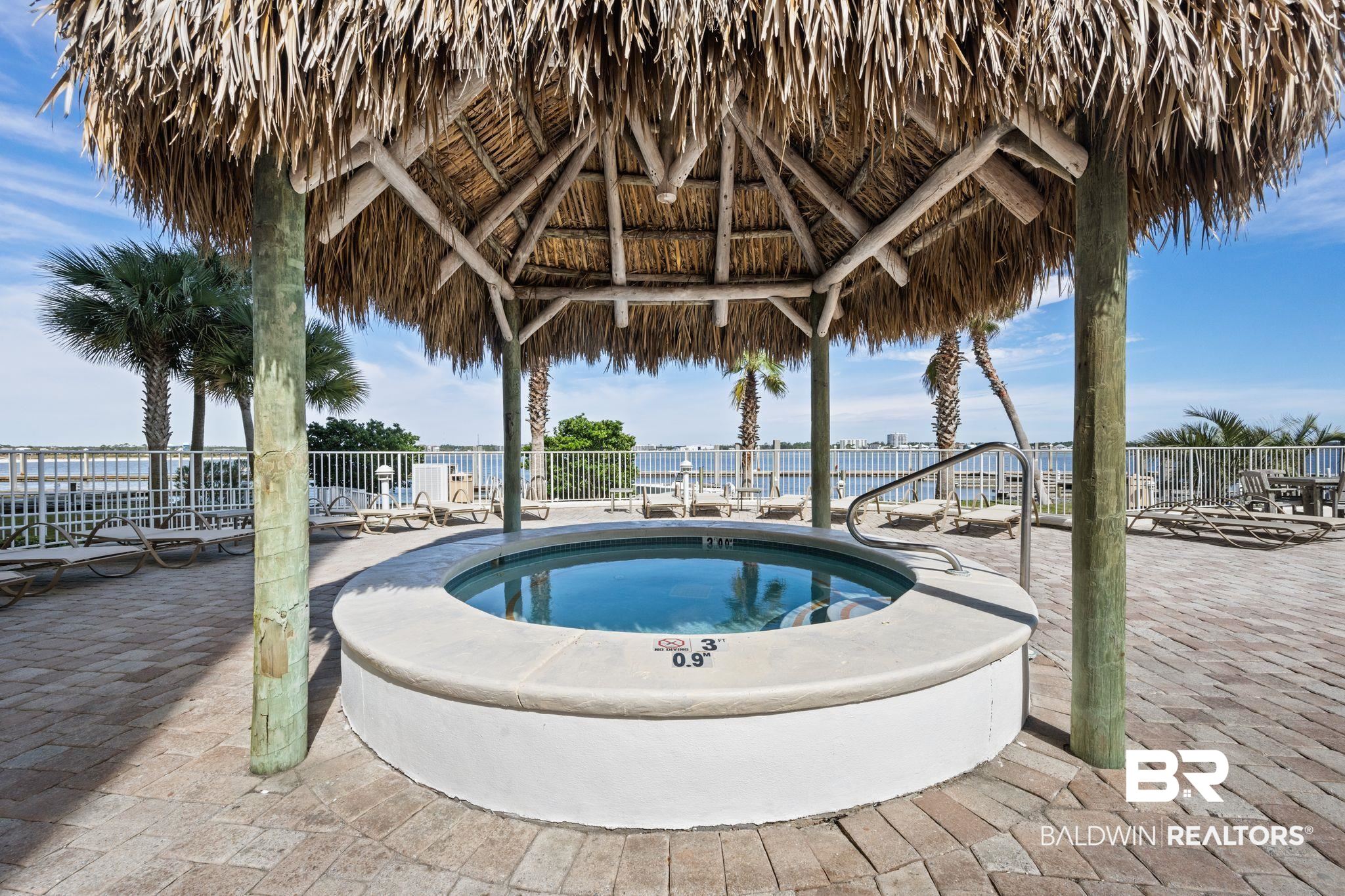28107 Perdido Beach Boulevard, Unit D714 Orange Beach, AL 36561 - Photo 66 of 88 View of swimming pool with a gazebo, a community hot tub, a patio area, and a water view