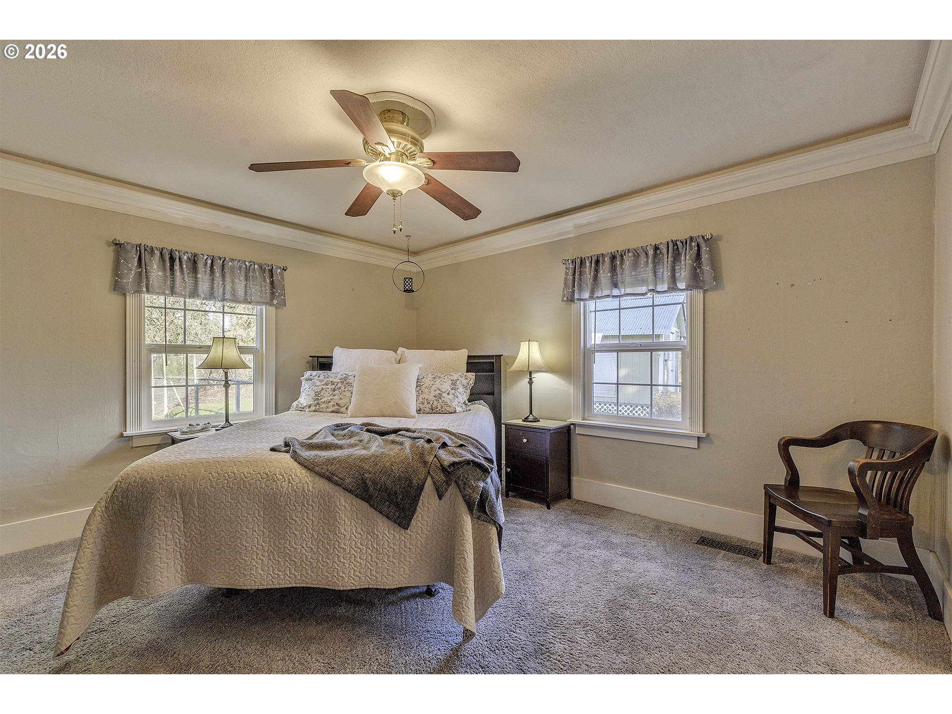 58059 Shadley Lane Warren, OR 97053 - Photo 18 of 39 a bedroom with a bed a chair and a window
