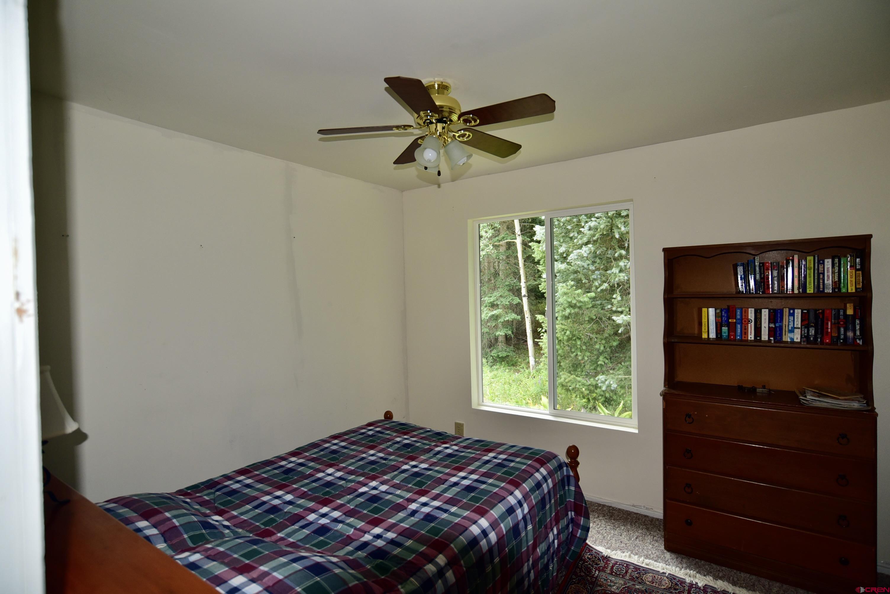 704 Hampton Road Montrose, CO 81220 - Photo 16 of 45 a bedroom with a bed and a window