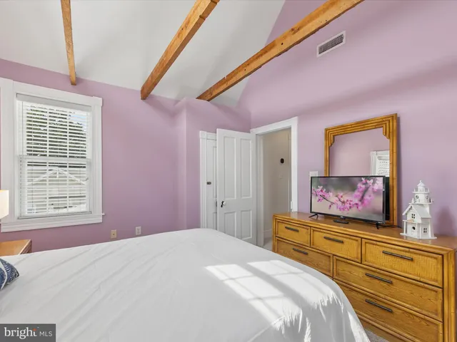 a bedroom with two beds and a chandelier
