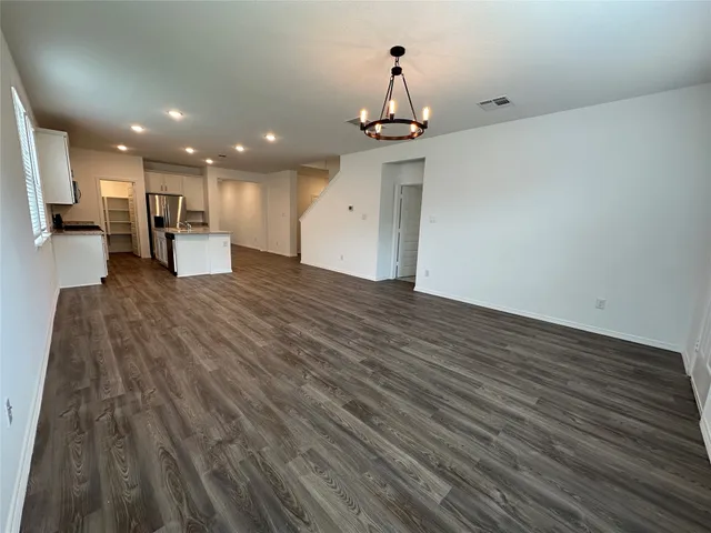 a view of a kitchen with wooden floor and a sink