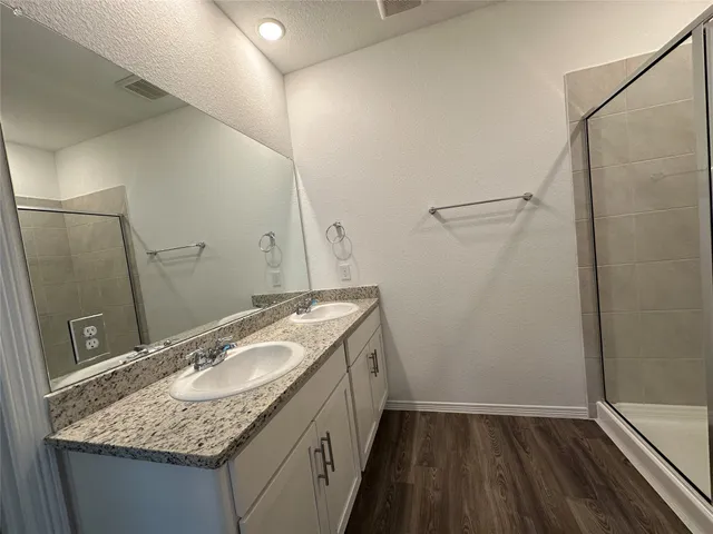 a bathroom with a granite countertop sink and a mirror