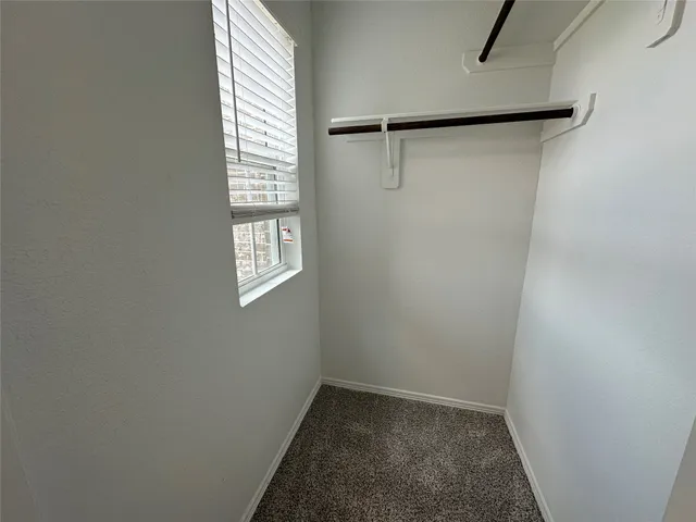 a view of a room with rack on the wall and shower