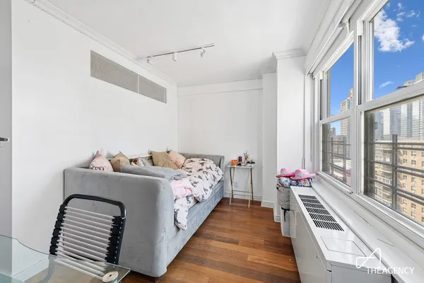 a bedroom with a bed a desk and chair