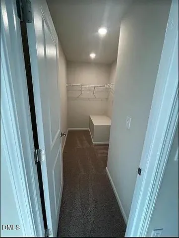 a spacious bathroom with a toilet sink and mirror