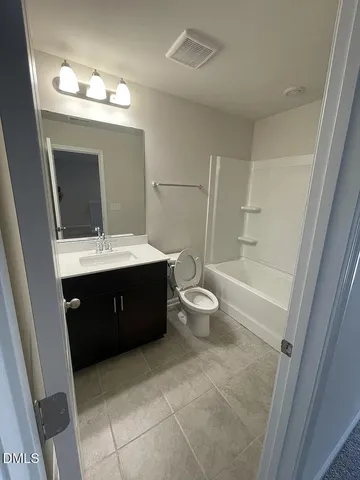 a bathroom with a double vanity sink and mirror