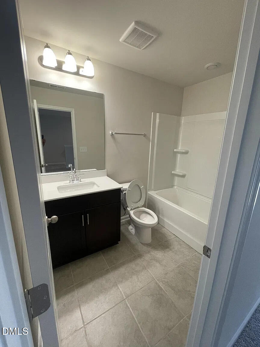 930 Field Ivy Drive Fuquay-Varina, NC 27526 - Photo 15 of 29 a spacious bathroom with a toilet sink and mirror