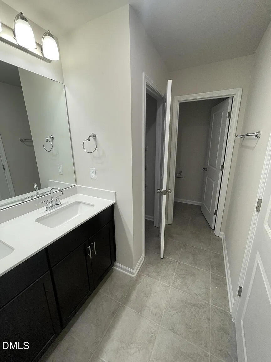 930 Field Ivy Drive Fuquay-Varina, NC 27526 - Photo 16 of 29 a bathroom with a double vanity sink and mirror