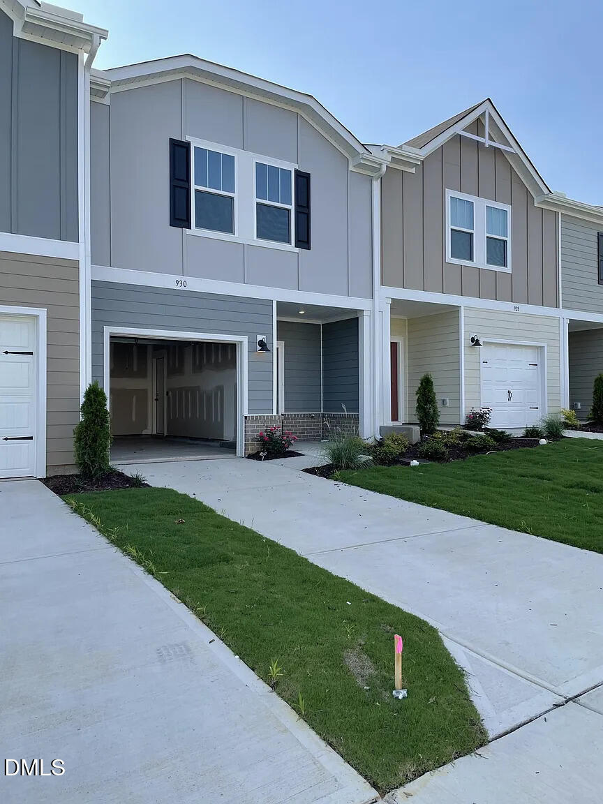 930 Field Ivy Drive Fuquay-Varina, NC 27526 - Photo 2 of 29 a front view of a house with a garden and yard