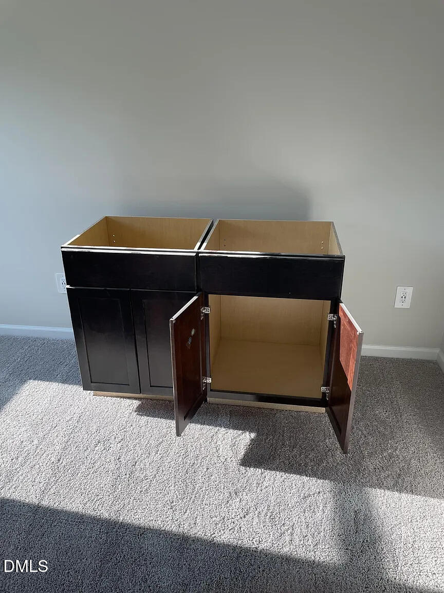 930 Field Ivy Drive Fuquay-Varina, NC 27526 - Photo 28 of 29 a living room with a bed and a table