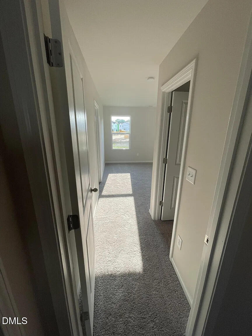 930 Field Ivy Drive Fuquay-Varina, NC 27526 - Photo 10 of 29 a view of a livingroom from a hallway