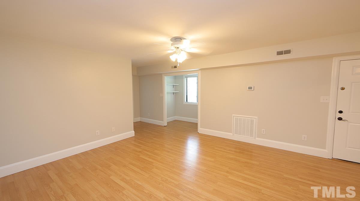 2208 Stafford Avenue, Unit 202 Raleigh, NC 27607 - Photo 5 of 15 wooden floor in an empty room with a window