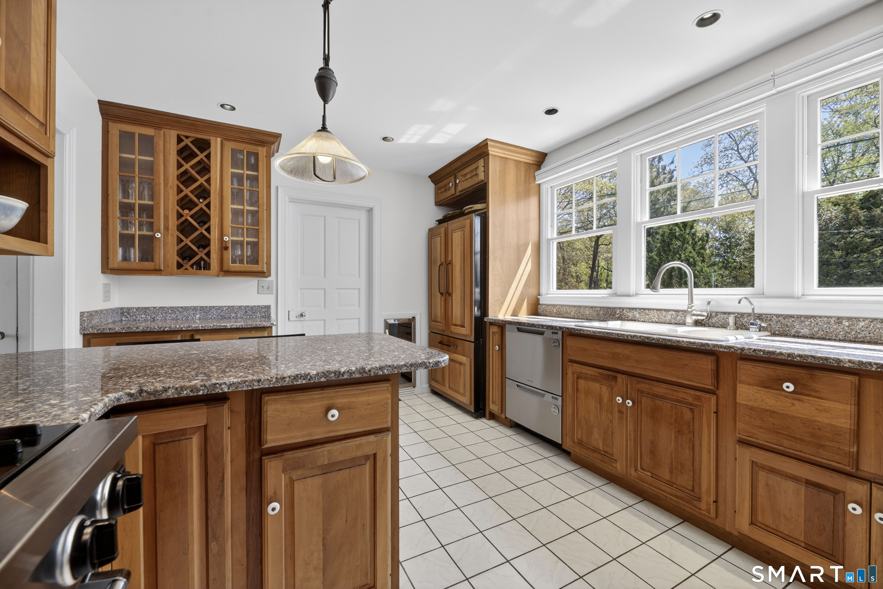 32 Money Point Road Stonington, CT 06355 - Photo 10 of 40 a kitchen with granite countertop cabinets a sink a window and stainless steel appliances