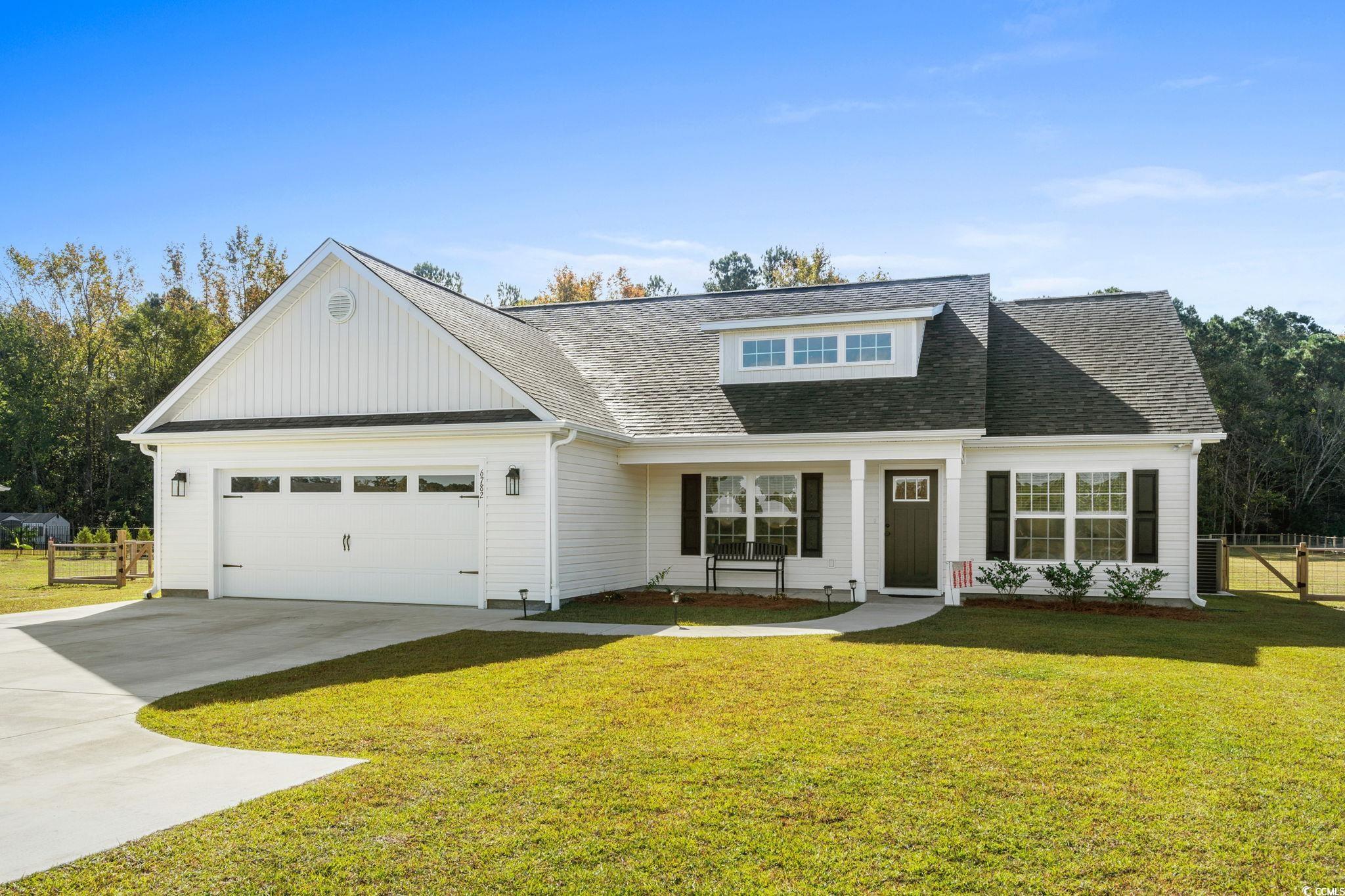 6782 Highway 366 Conway, SC 29526 - Photo 1 of 37 View of front facade with concrete driveway, roof with shingles, a porch, a garage, and board and batten siding