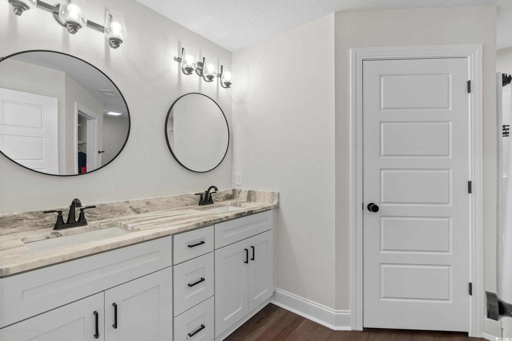 6782 Highway 366 Conway, SC 29526 - Photo 12 of 37 Kitchen featuring stainless steel appliances, dark wood finished floors, dark brown cabinetry, light stone counters, and decorative light fixtures
