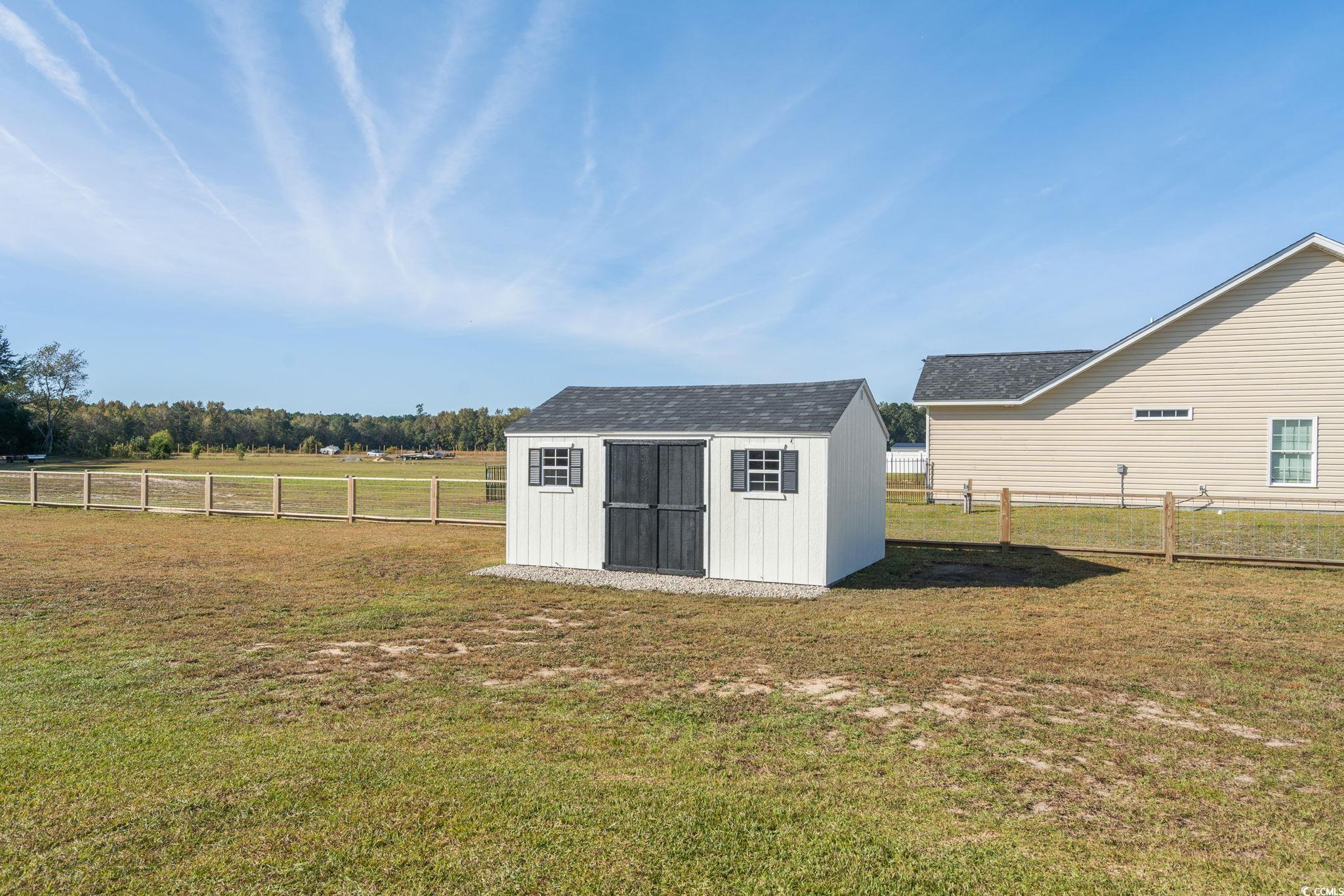 6782 Highway 366 Conway, SC 29526 - Photo 26 of 37 Fenced backyard with a patio, a pergola, and view of scattered trees